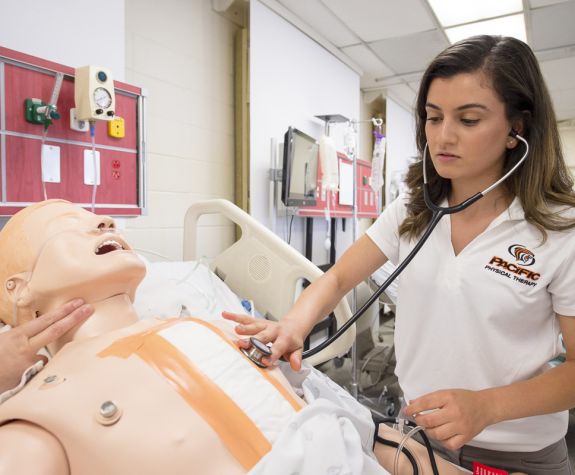 student working with healthcare dummy