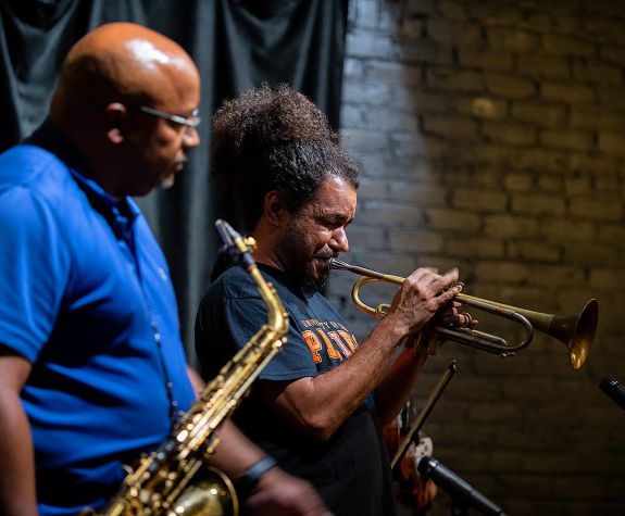 People playing trumpet and and saxophone