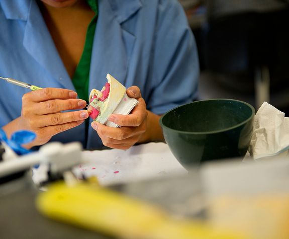 dental student working on a model