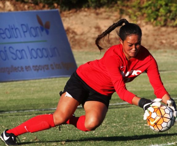 soccer goalie diving for ball