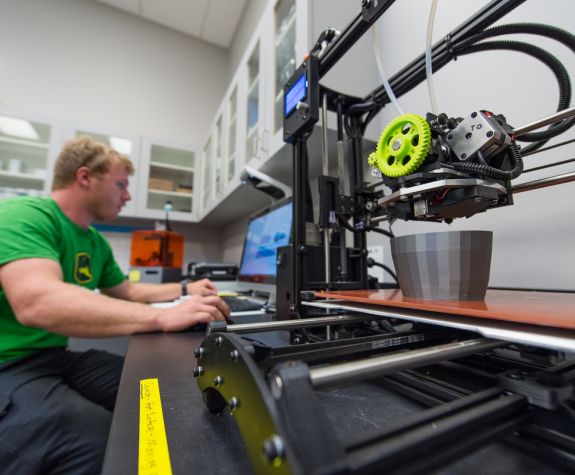 student with a 3d printer
