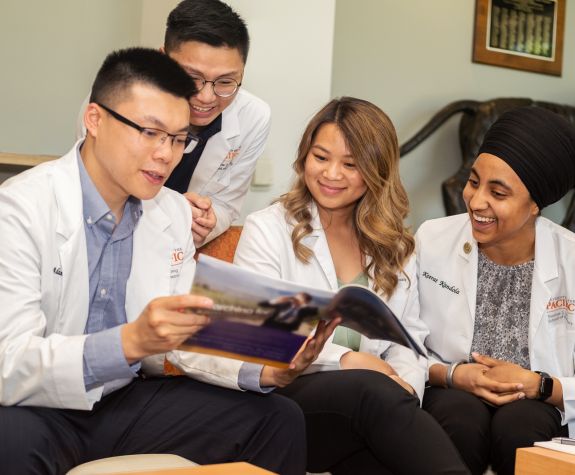 four doctor of pharmacy students in lounge