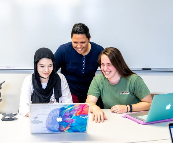 Dr. Laura Hallberg with 2 students