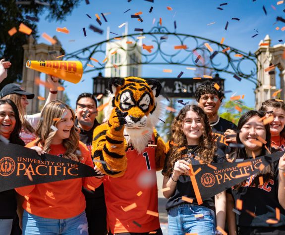 students cheering in front of the gate