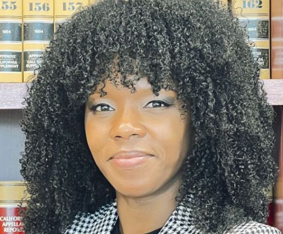 A portrait of a woman in front of bookcase