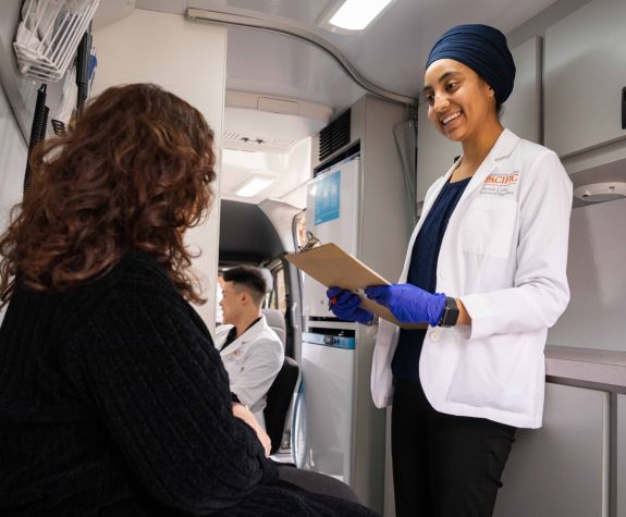 Doctor of pharmacy student with patient in mobile clinic van