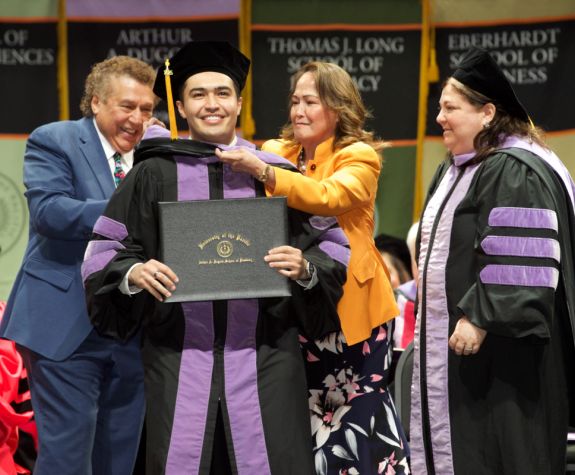 A student is awarded their diploma