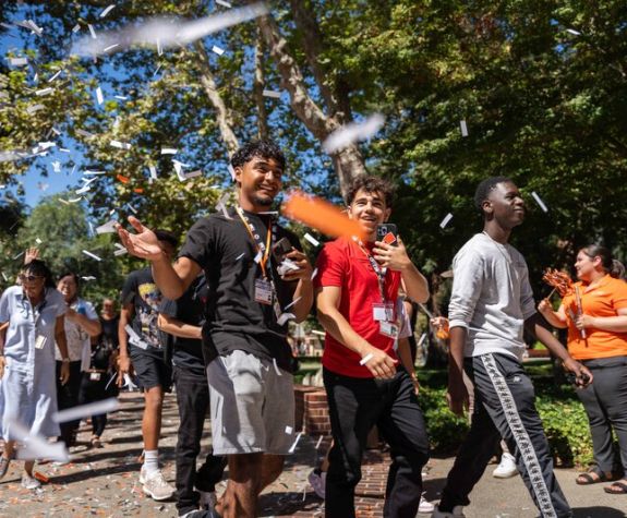 students walking together with confetti in the air
