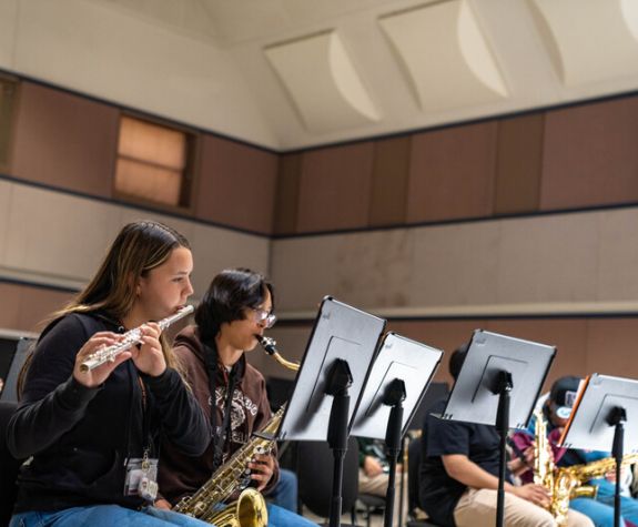 People playing trumpet and and saxophone