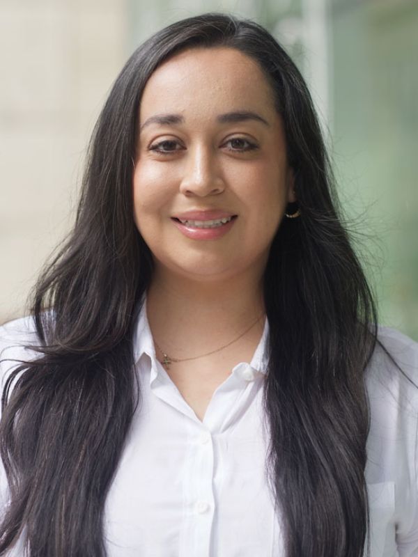 Maritza Perez is a woman with a white shirt and brown hair