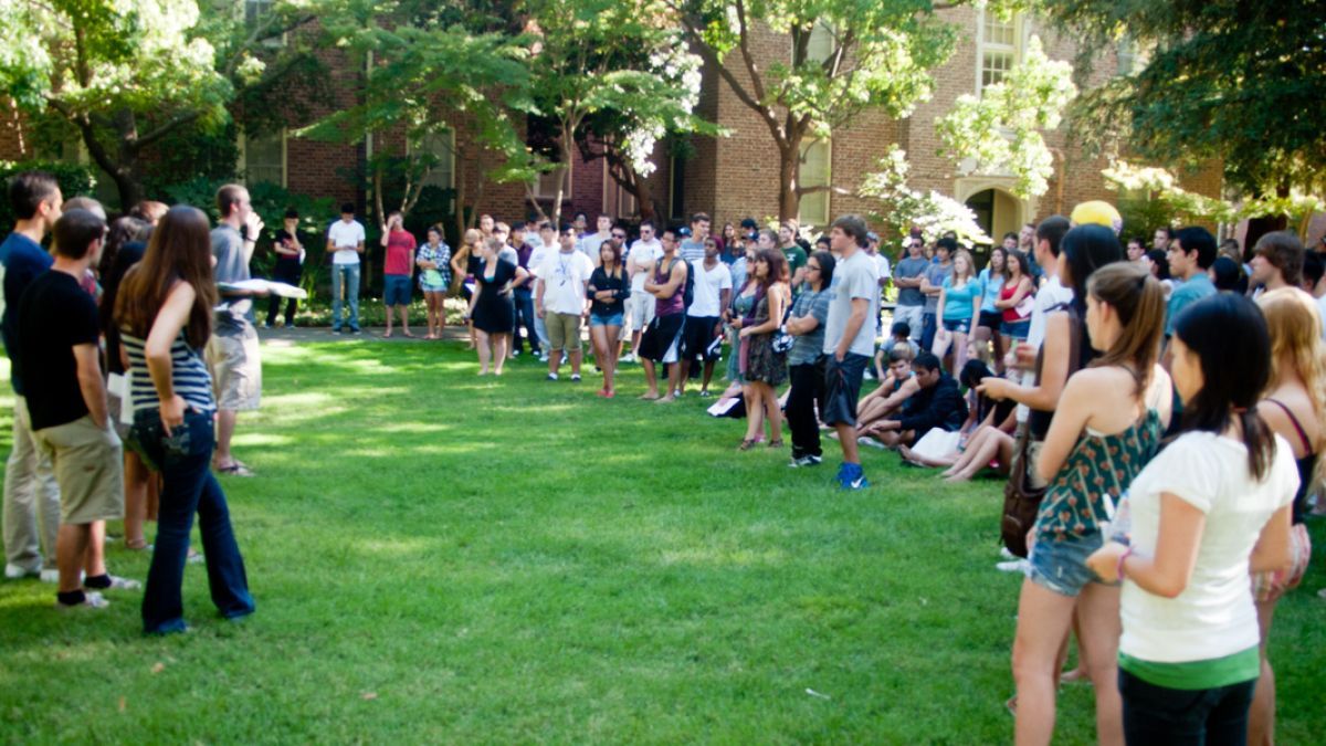 Students gather on the lawn outside Southwest Hall during orientation. 