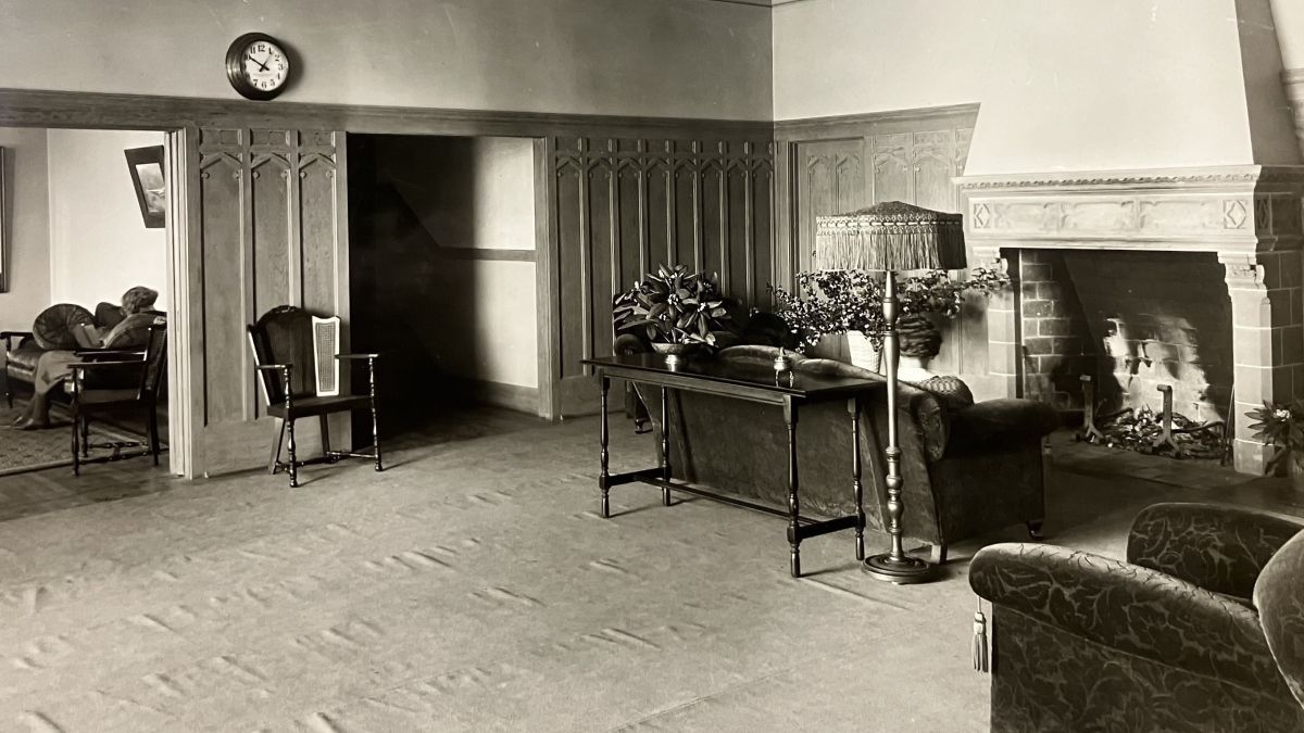 A woman reads in one of the South Hall parlors.