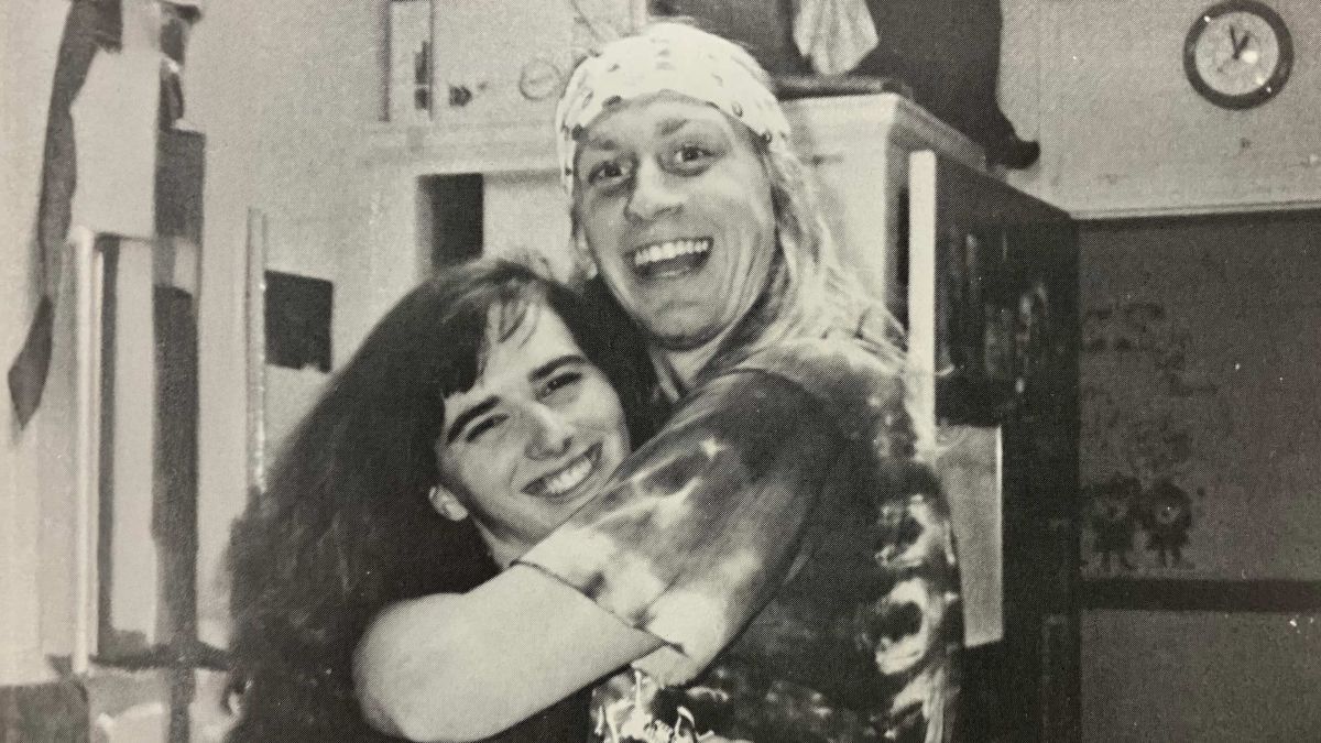 A couple hugs each other.