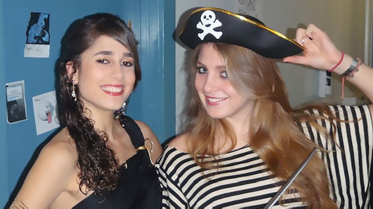 Two students dressed as pirates pose for the camera. 