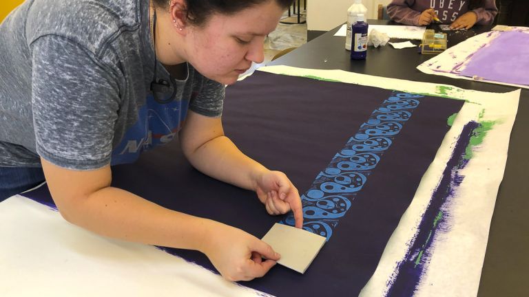 Student creating block prints