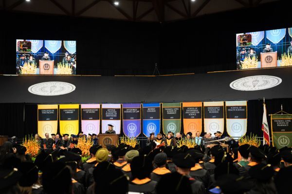 the commencement stage with school flags