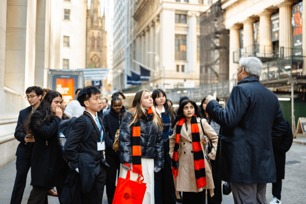 students walking on wall street