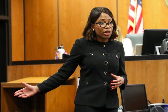 Woman in a suit speaks in courtroom