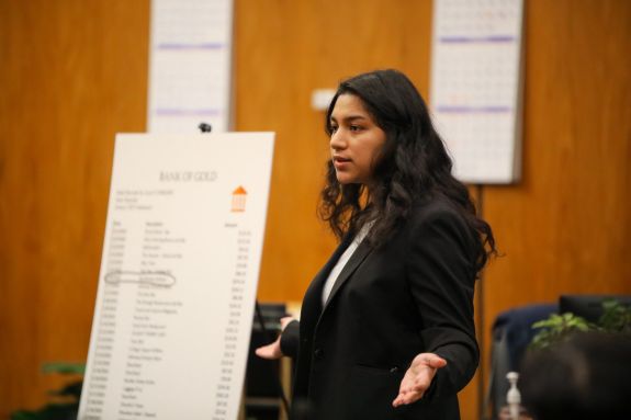 Woman in a suit speaks in courtroom