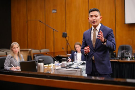 Man in a suit speaks in courtroom