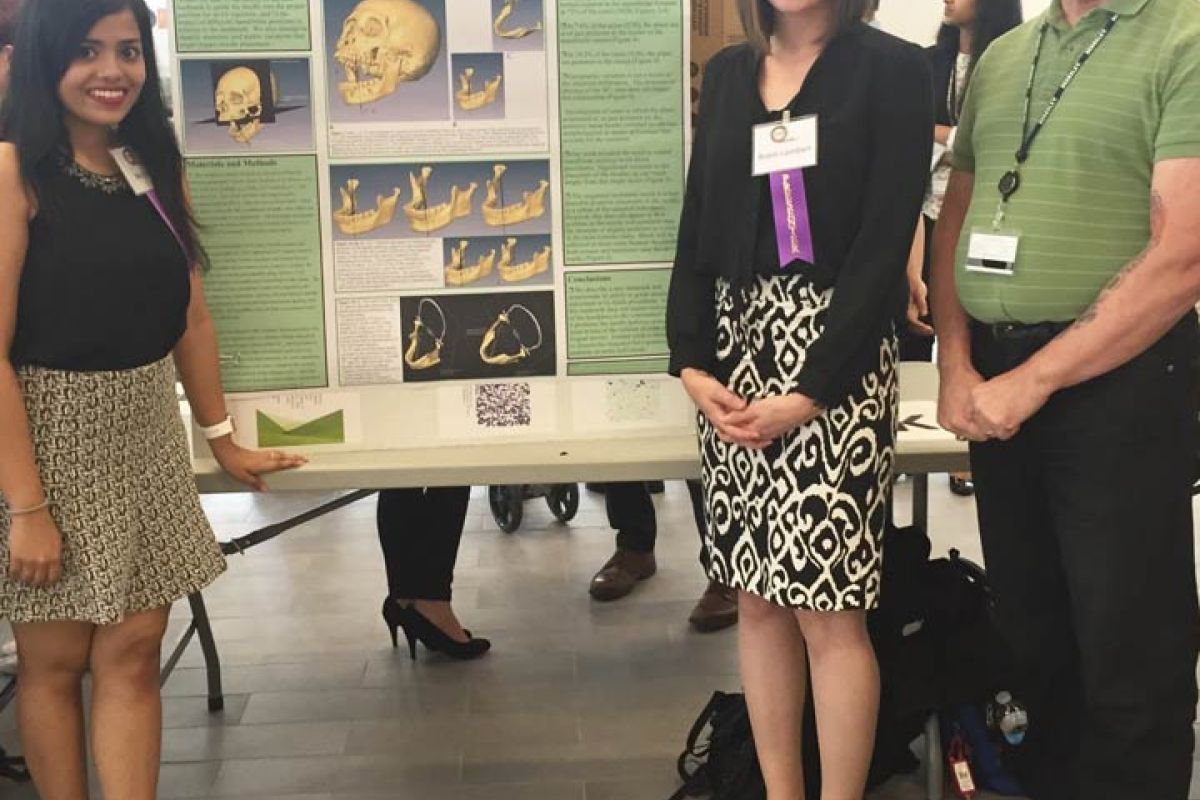 Students Robin Lambert and Riddhima Suri, members of the DDS Class of 2017, along with their faculty advisor Dr. Gary D. Richards, pose with the poster for their project, "A New Insertion Landmark and Modification of the 'Standard Technique' for Inferior Alveolar Nerve Block Injections".
