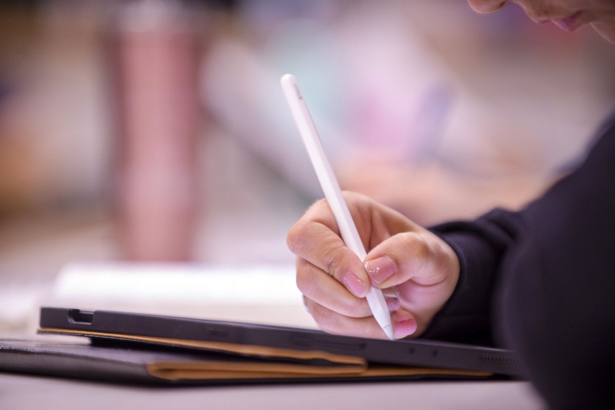student using tablet in classroom
