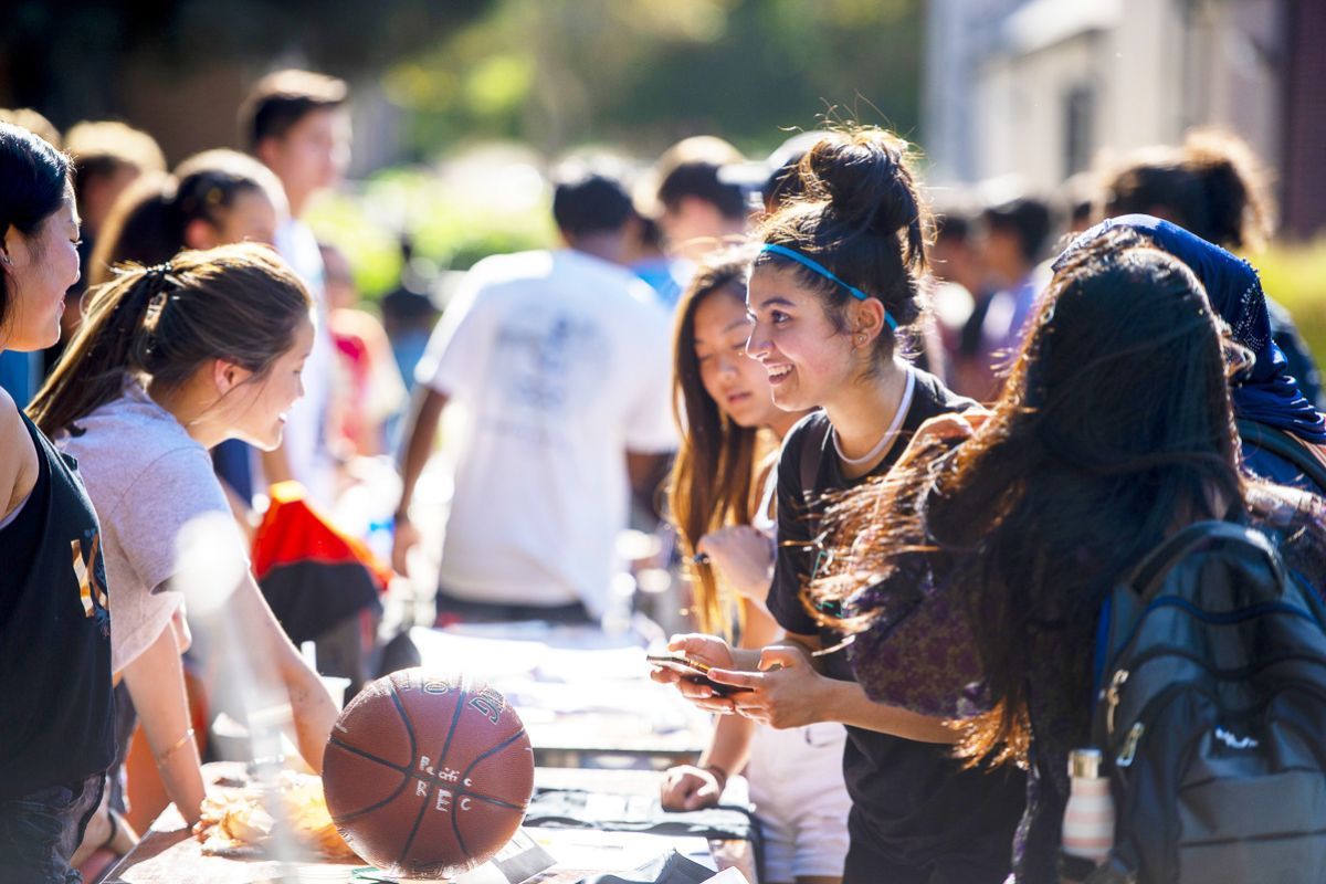 students learn about clubs and organizations at club fair