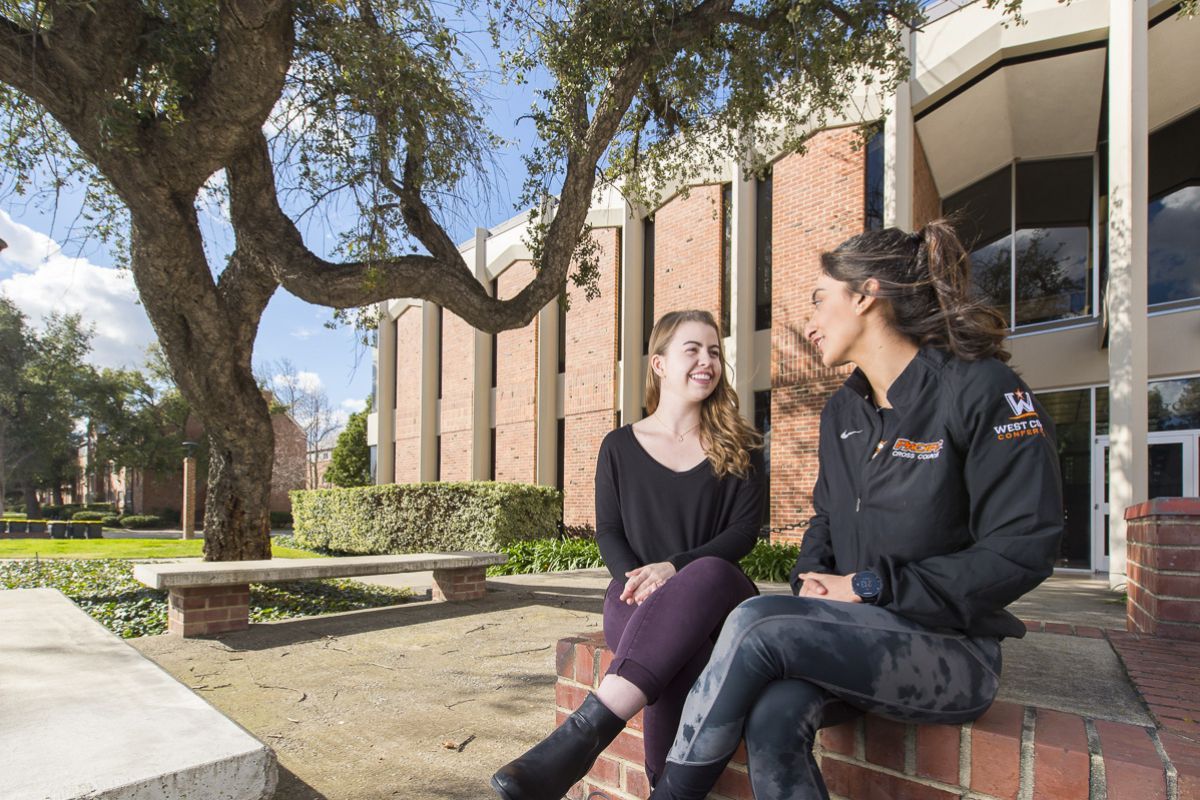 two students sit outside Wendell Phillips Center