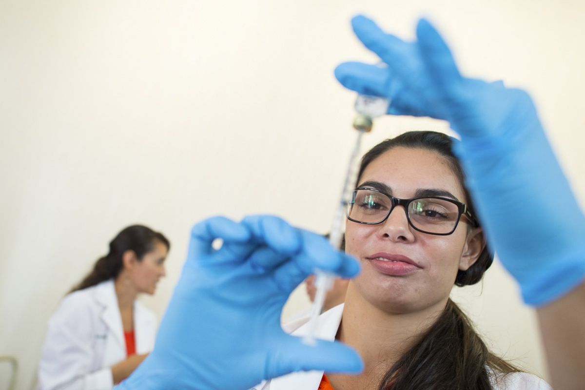 a pharmacy student prepares a flu shot