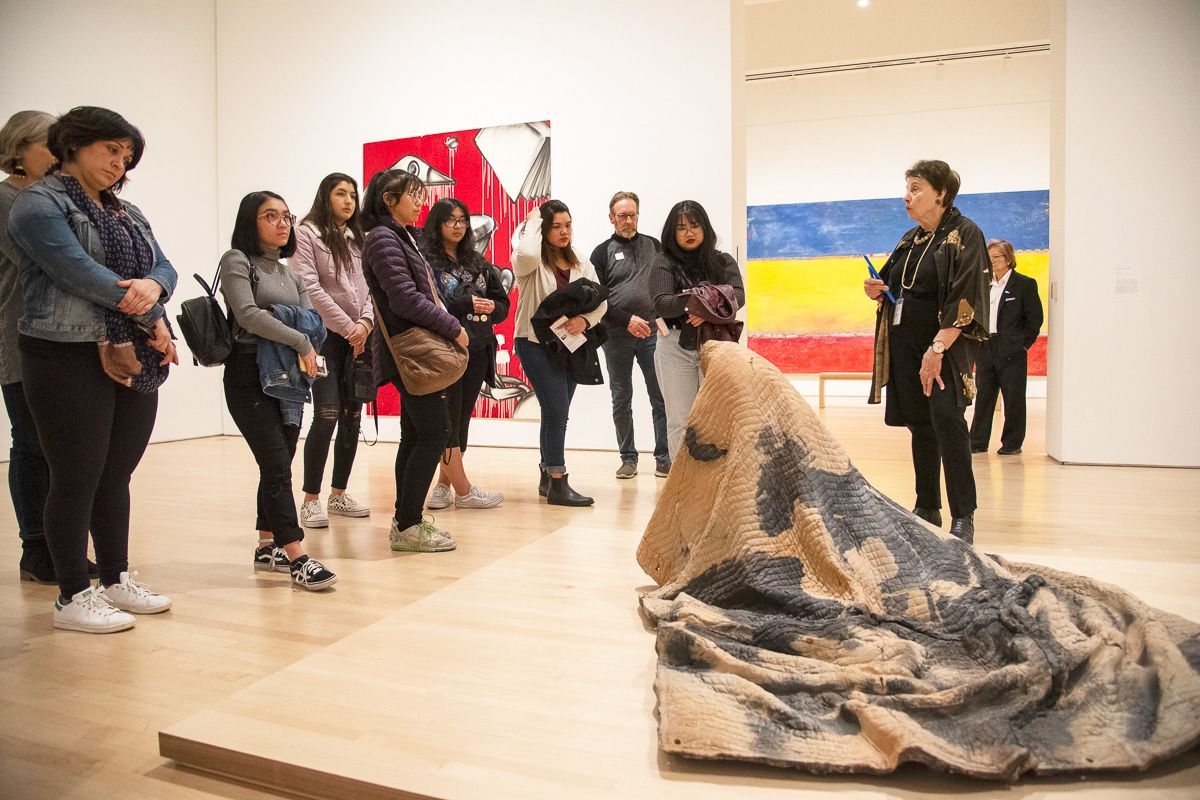 students look at artwork during a Humanities trip to SF MOMA