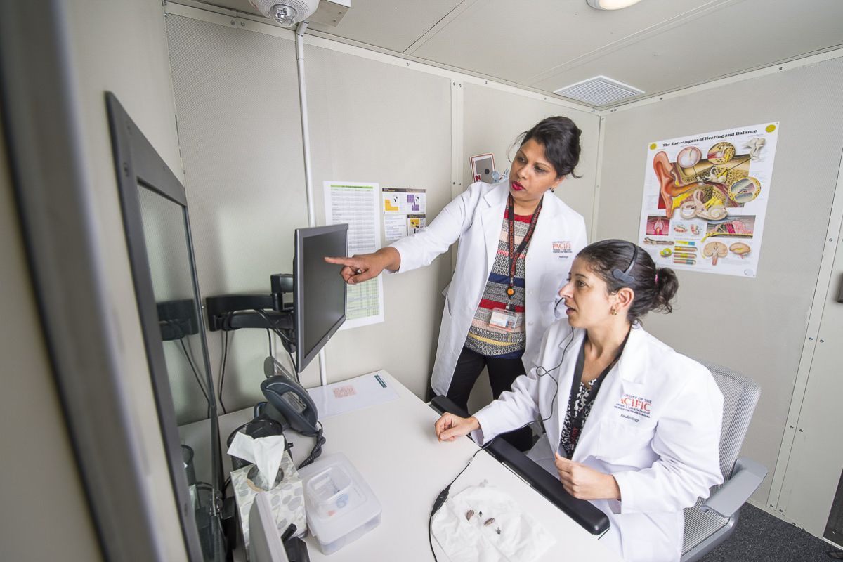 Rupa Balachandran, director of the doctor of audiology program in San Francisco, works along students in the clinic.