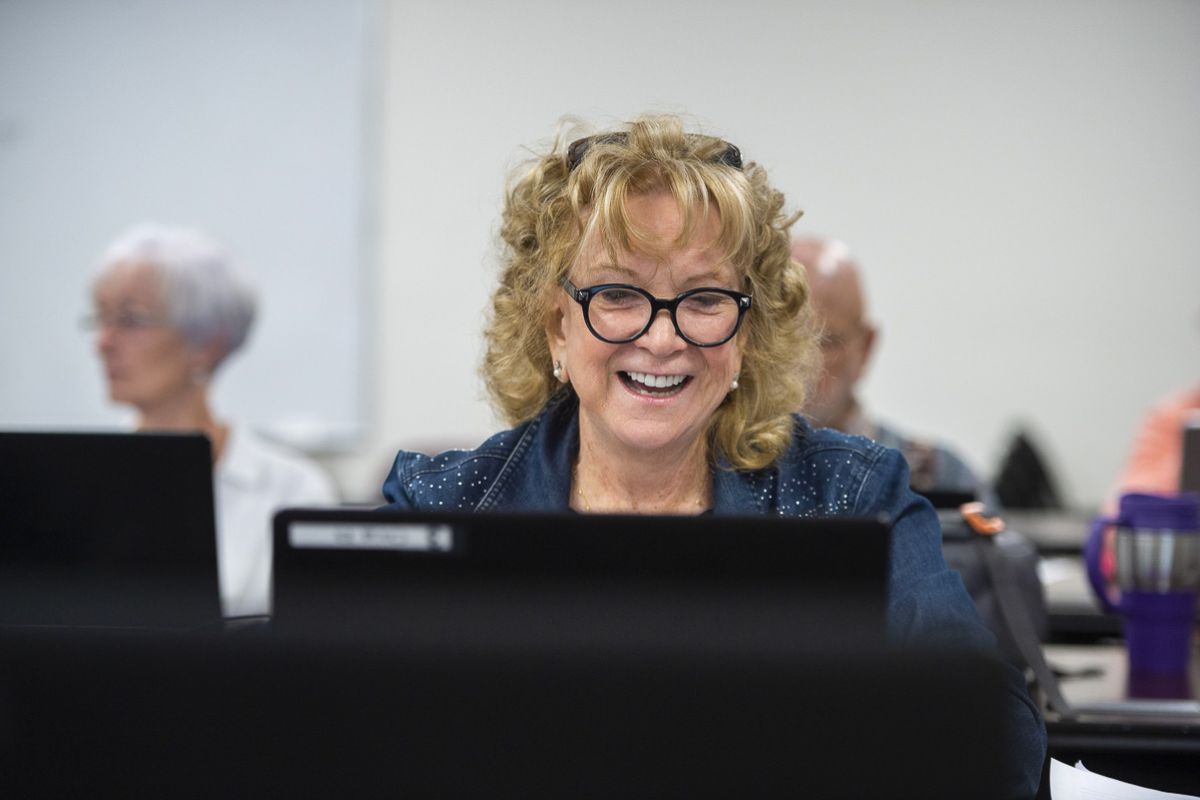 woman smiling and using laptop