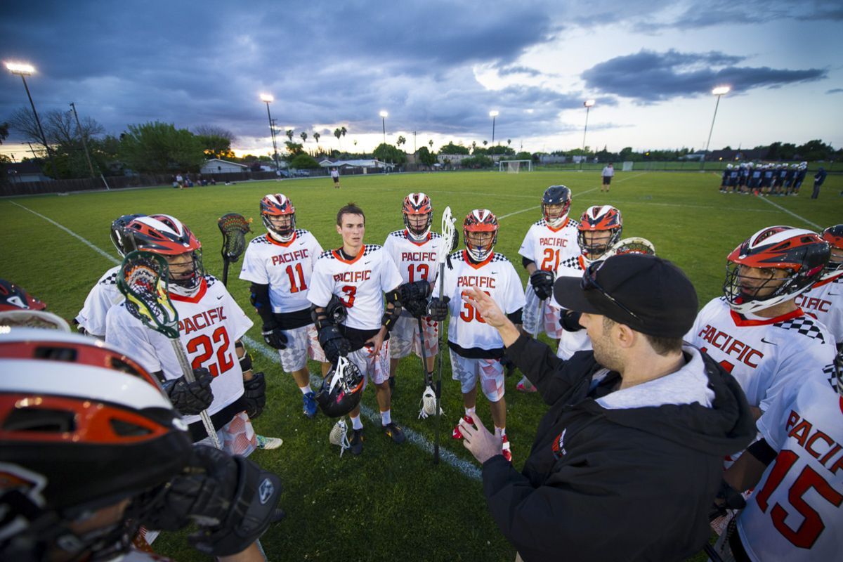 coach talking to lacrosse players