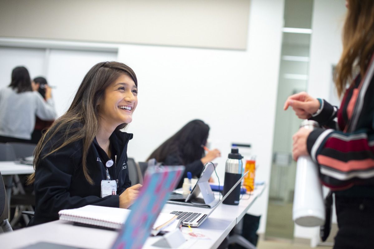 students smiling at desk