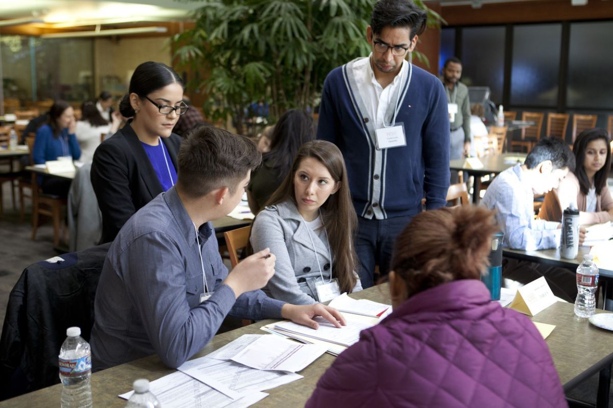 students helping at the mcgeorge immigration fair