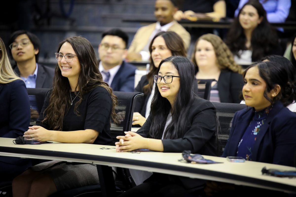 group of students sitting and smiling