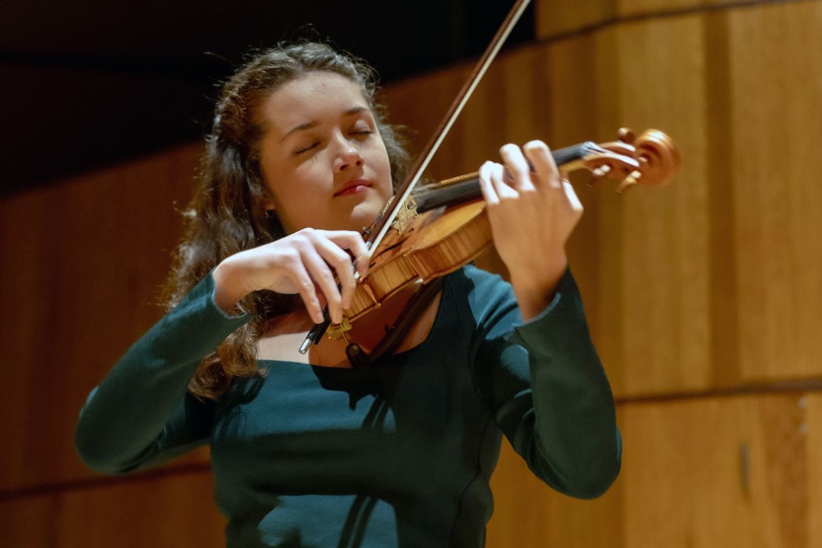 A master's in music education student playing the violin