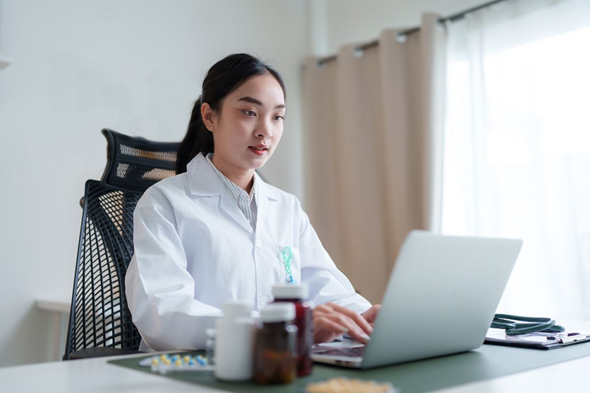 Health professional working on their laptop