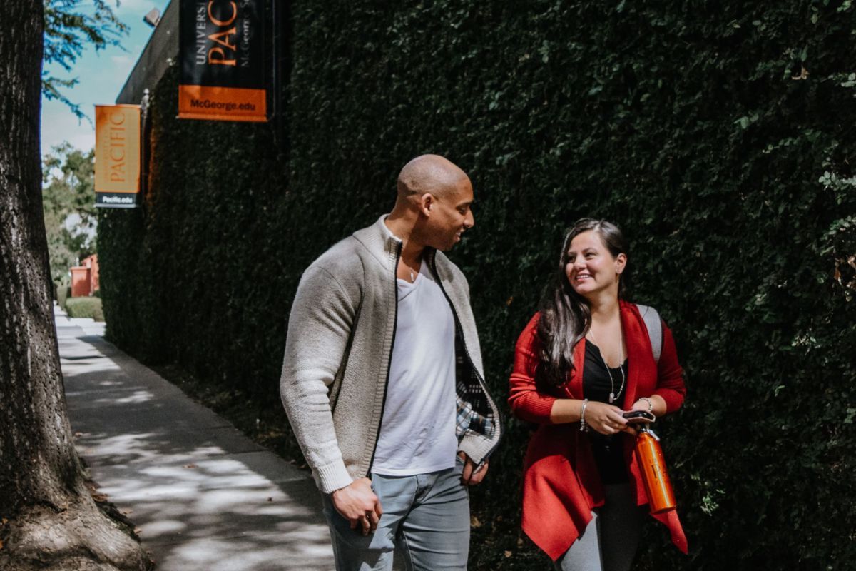 Photo shows two students walking on the Sacramento campus. 