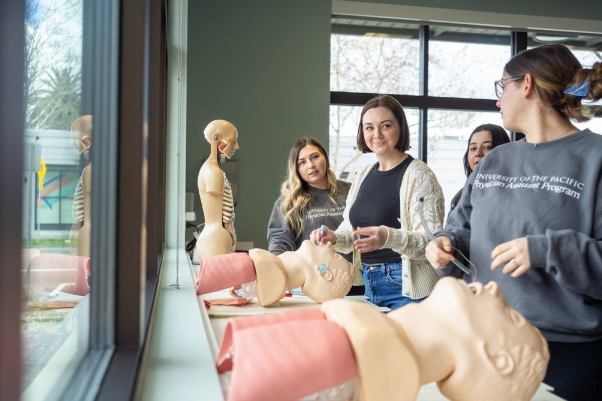 Image shows students practicing a procedure. 