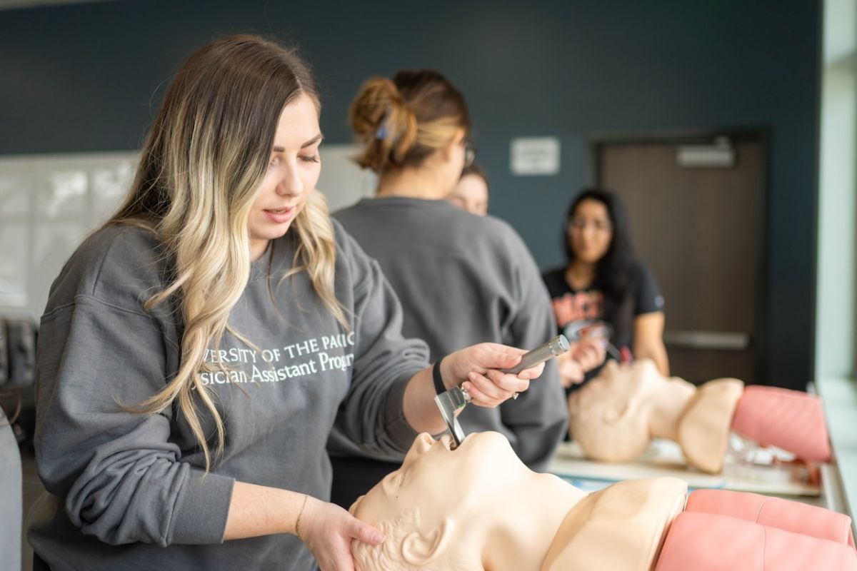 Image shows students practicing procedures on mannequins