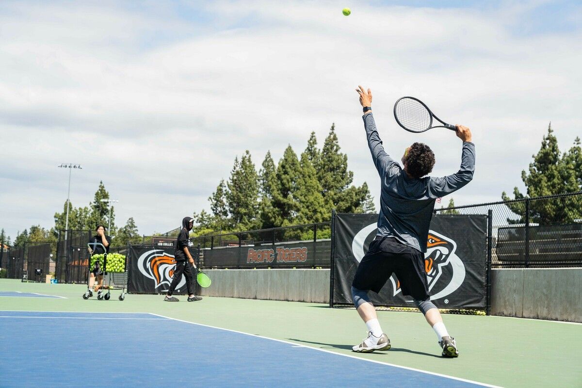 Tennis student serving