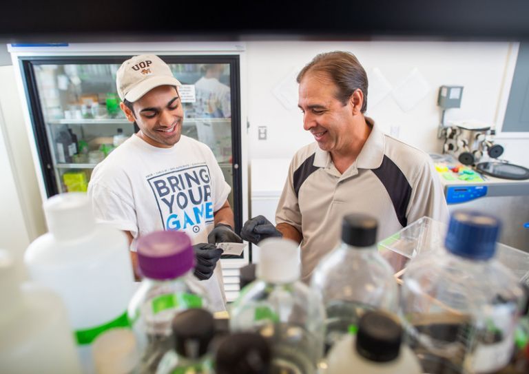 student and professor in the lab