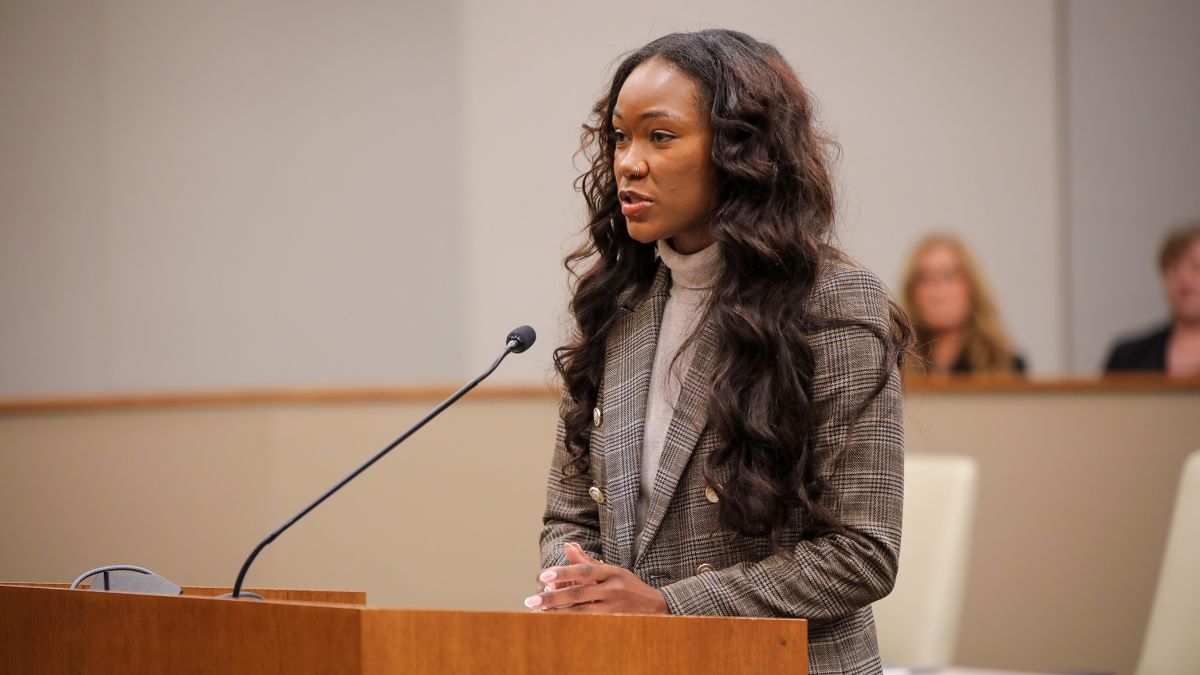 a law student stands at a podium