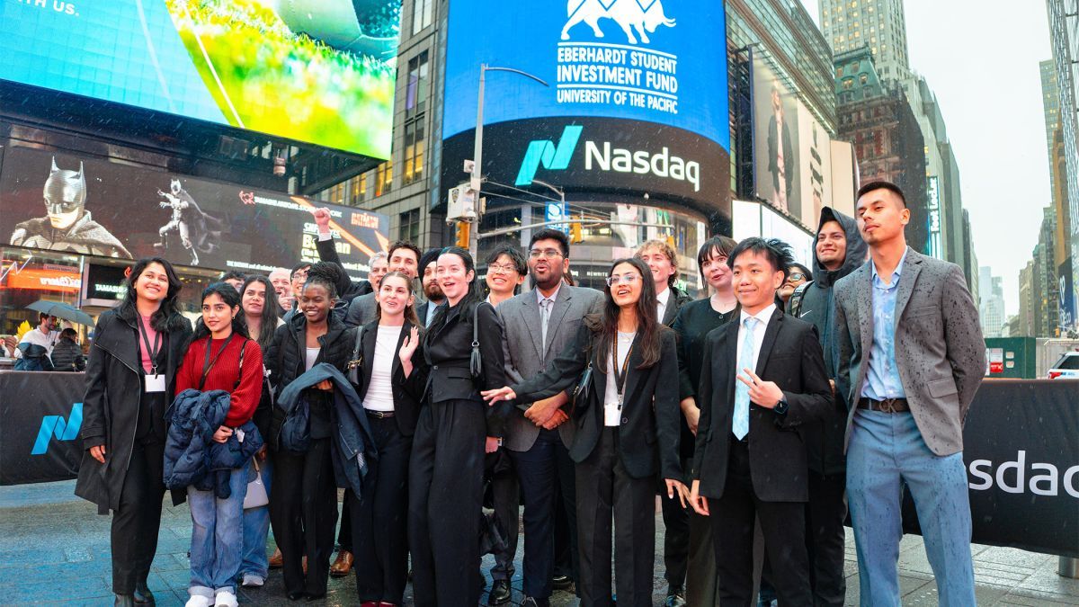 Students post in front of NASDAQ