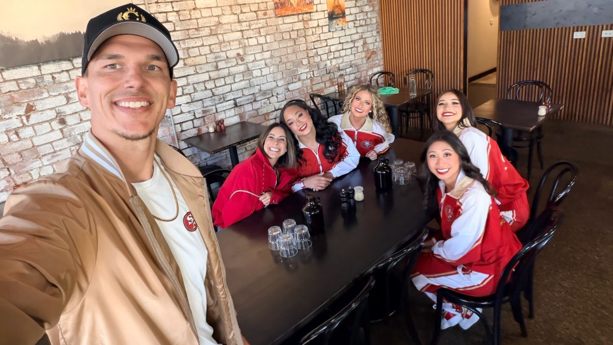 STUNT coach smiling in a selfie with the team