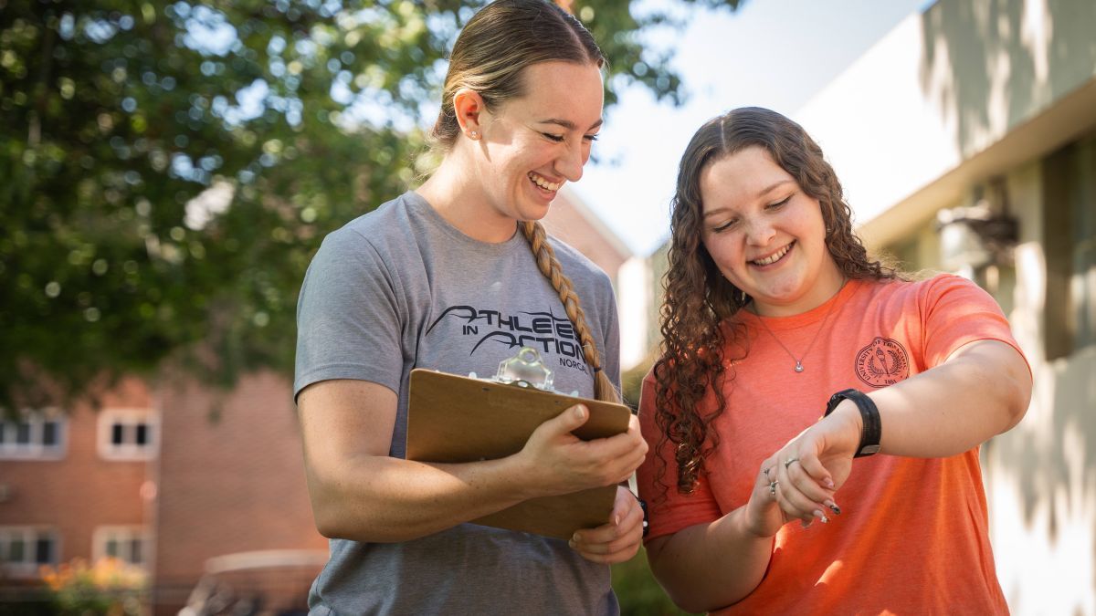 Two students looking at fitness tracker