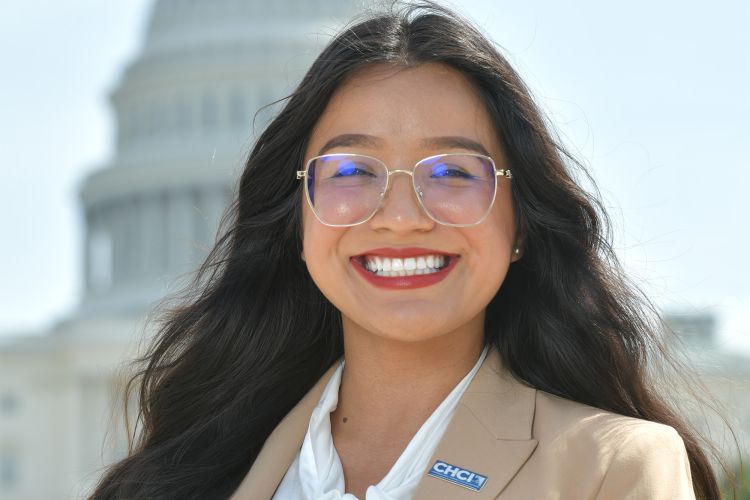 A close up photo of a woman in front of a government building 