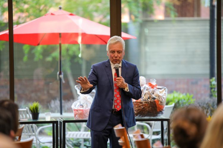 Man speaking into a microphone at an event.