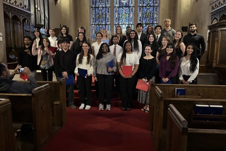 Students standing in Morris Chapel smiling